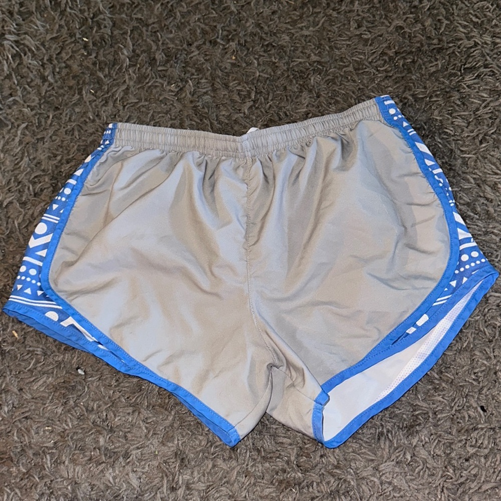 Varsity spirit athletic shorts. Grey with blue patterns on side. Size M